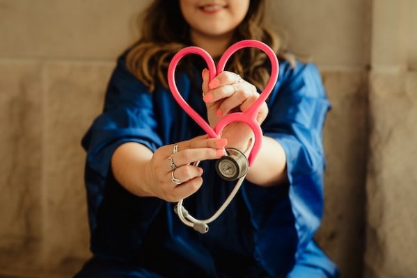 a nurse with a stethoscope in the shape of a heart 